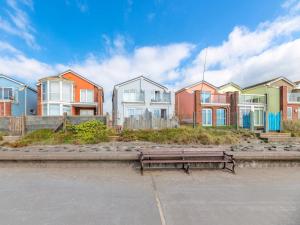 a park bench in front of a row of houses at 2 Bed in Tywyn oc-dy052 in Tywyn
