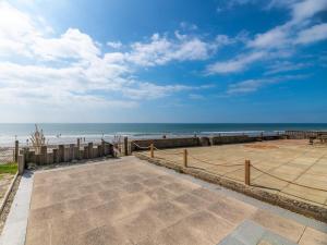 a view of the beach from a parking lot at 2 Bed in Tywyn oc-dy052 in Tywyn +11 photos
