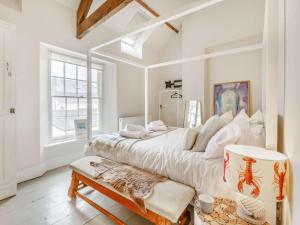 a white bedroom with a large bed and a window at 4 Bed in Bideford oc-88876 in Appledore