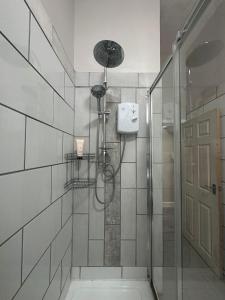 a shower with a glass door in a bathroom at Spacious Victorian Apt Sleeps 5 Parking available in Nottingham