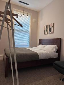 a bedroom with a bed and a ladder in it at Spacious Victorian Apt Sleeps 5 Parking available in Nottingham +10 photos