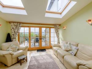 a living room with two couches and a skylight at 2 Bed in Colwyn Bay oc-74147 in Eglwys-Fâch