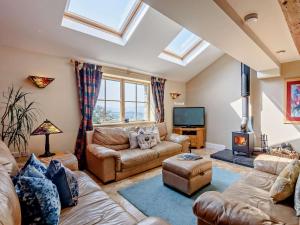 a living room with a couch and a tv at 3 Bed in Colwyn Bay oc-74146 in Eglwys-Fâch