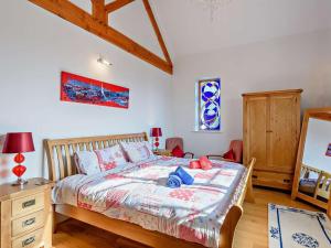 a bedroom with a bed and a wooden dresser at 3 Bed in Colwyn Bay oc-74146 in Eglwys-Fâch