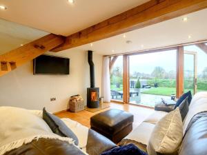 a living room with a couch and a fireplace at 1 Bed in South Molton oc-59339 in Knowstone