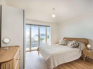 a bedroom with a bed and a large window at 4 Bed in Aberdovey oc-87586 in Aberdyfi