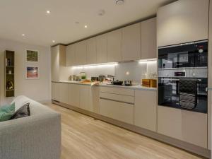 a kitchen with white cabinets and a stove top oven at 2 Bed in Porthcawl oc-89696 in Porthcawl