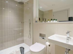 a bathroom with a shower and a toilet and a sink at 2 Bed in Porthcawl oc-89696 in Porthcawl +18 photos