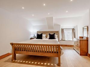 a bedroom with a large bed with black pillows at 1 Bed in Barnstaple oc-91612 in Bishops Tawton
