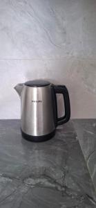 a black and silver coffee pot sitting on a counter at Salmaan Villa in Grand-Baie