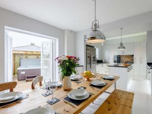 a kitchen and dining room with a table and chairs at 4 Bed in Llandudno oc-75466 in Llandudno