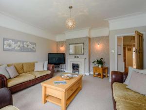 a living room with couches and a coffee table at 4 Bed in Llandudno oc-75466 in Llandudno