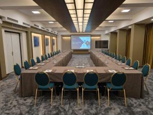a large conference room with a long table and chairs at Hotel Bellevue in Skopje