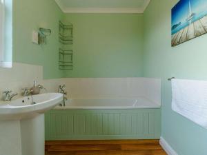 a bathroom with a sink and a bath tub at 3 Bed in Richmond oc-90578 in Catterick Bridge +31 photos