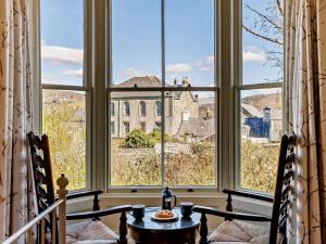 a room with two chairs and a table in front of a window at 6 Bed in Dolgellau oc-91711 in Dolgellau
