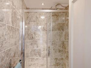a shower with a glass door in a bathroom at 6 Bed in Dolgellau oc-91711 in Dolgellau +33 photos