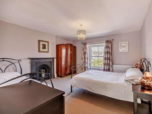 a bedroom with two beds and a fireplace at 6 Bed in Dolgellau oc-91711 in Dolgellau
