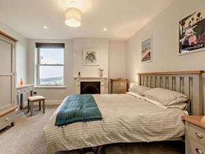 a bedroom with a bed and a fireplace at 2 Bed in Woolacombe oc-90798 in Mortehoe