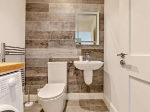 a bathroom with a toilet and a sink at 2 Bed in Woolacombe oc-90798 in Mortehoe +12 photos