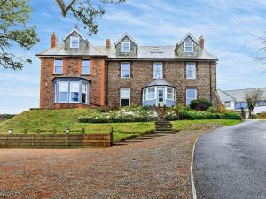 a large brick house on the side of a road at 2 Bed in Woolacombe oc-90798 in Mortehoe