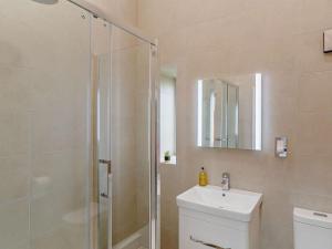 a bathroom with a shower and a toilet and a sink at 2 Bed in Wakefield oc-93235 in Crofton +8 photos
