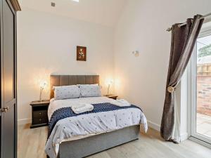 a bedroom with a bed and a large window at 2 Bed in Wakefield oc-93235 in Crofton