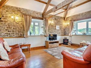 a living room with a couch and a tv at 2 Bed in Bridport oc-94222 in Bridport