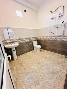 a bathroom with a toilet and a sink at Surf Bay Hotel in Arugam Bay