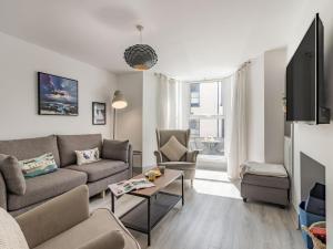 a living room with a couch and a table at 3 Bed in Brixham oc-88116 in Brixham