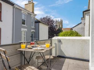 a small table on a balcony with two glasses of orange juice at 3 Bed in Brixham oc-88116 in Brixham
