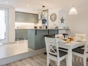 a kitchen and dining room with a white table and chairs at 3 Bed in Brixham oc-88116 in Brixham