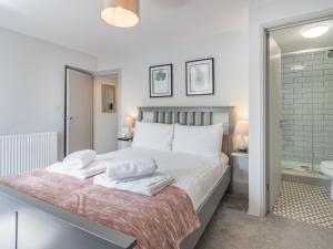 a bedroom with a large bed with towels on it at 3 Bed in Brixham oc-88116 in Brixham