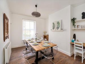 a dining room with a wooden table and chairs at 5 Bed in Ilfracombe oc-89563 in Ilfracombe