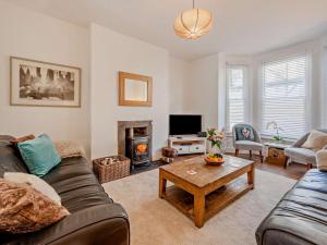 a living room with a couch and a fireplace at 5 Bed in Ilfracombe oc-89563 in Ilfracombe