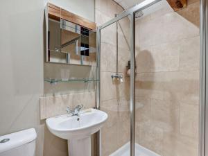 a bathroom with a shower and a sink and a toilet at 3 Bed in Heathfield oc-93718 in Dallington