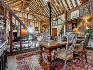 a dining room with a wooden table and chairs at 3 Bed in Heathfield oc-93718 in Dallington