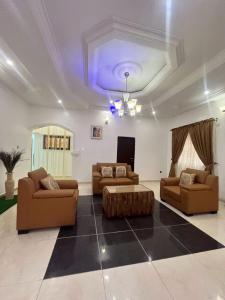 a living room with two couches and a coffee table at Shana Homes in Karsana