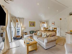 a living room with a couch and a table at 3 Bed in Okehampton oc-95636 in Okehampton
