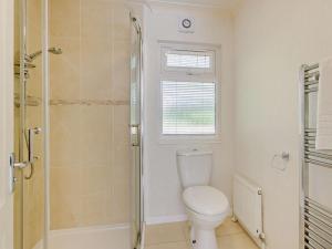 a bathroom with a toilet and a shower at 3 Bed in Okehampton oc-95636 in Okehampton +7 photos
