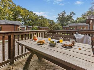 a wooden table with food on top of a deck at 3 Bed in Okehampton oc-95636 in Okehampton