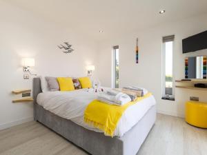 a bedroom with a large bed with yellow pillows at 1 Bed in Ilfracombe oc-52915 in Ilfracombe