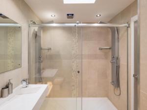 a bathroom with a glass shower with a sink and a tub at 1 Bed in Ilfracombe oc-52915 in Ilfracombe