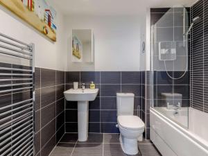 a bathroom with a toilet and a sink and a shower at 2 Bed in Y Felinheli oc-86260 in Y Felinheli