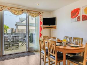 a dining room with a table and chairs and a television at 3 Bed in Watchet oc-37336 in Watchet