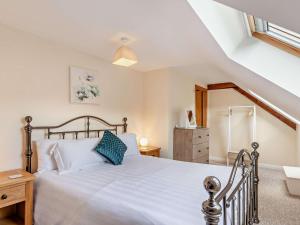 a bedroom with a large white bed and a staircase at 4 Bed in Ilfracombe oc-43640 in Berrynarbor