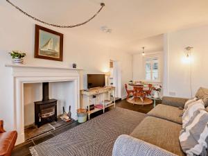 a living room with a couch and a fireplace at 2 Bed in Bideford oc-52863 in Appledore