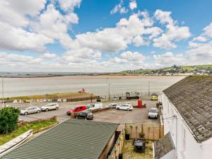 a parking lot next to a beach with cars parked at 2 Bed in Bideford oc-52863 in Appledore