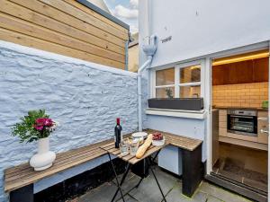 a small table with a bottle of wine on a patio at 2 Bed in Bideford oc-52863 in Appledore