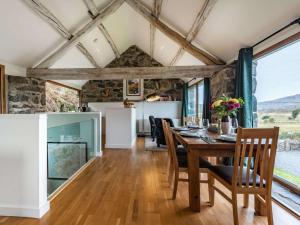a kitchen and dining room with a table and chairs at 2 Bed in Arthog oc-66611 in Arthog
