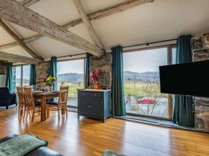 a living room with a table and a large window at 2 Bed in Arthog oc-66611 in Arthog